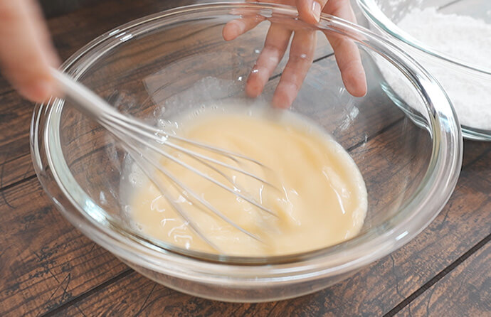 卵、はちみつ、牛乳を入れ、混ぜる様子